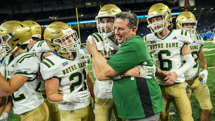 Pontiac Notre Dame Prep head coach Pat Fox hugs WR Joseph Decasas in celebration of their win against Frankenmuth 42-7, during the MHSAA Division 5 football finals at Ford Field in Detroit on Saturday, Nov. 30, 2024.