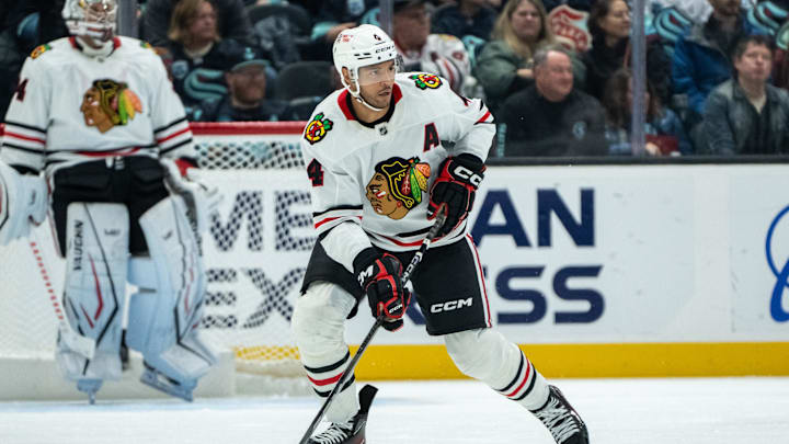Nov 14, 2024; Seattle, Washington, USA;  Chicago Blackhawks defenseman Seth Jones (4) skates with the puck against the Seattle Kraken at Climate Pledge Arena. Mandatory Credit: Stephen Brashear-Imagn Images