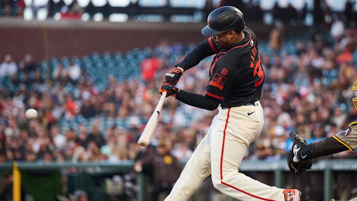 Sep 14, 2024; San Francisco, California, USA; San Francisco Giants infielder LaMonte Wade Jr. (31) hits a single against the San Diego Padres during the second inning at Oracle Park.