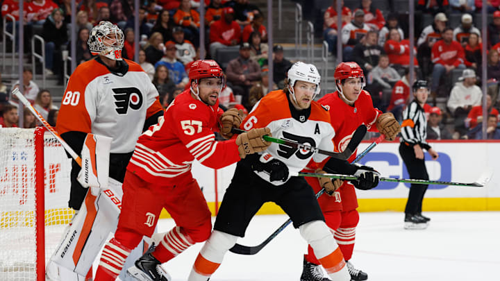 Mar 28, 2026; Detroit, Michigan, USA;  Detroit Red Wings left wing David Perron (57) and Philadelphia Flyers defenseman Travis Sanheim (6) fight for position in front of goaltender Dan Vladar (80) in the second period at Little Caesars Arena. Mandatory Credit: Rick Osentoski-Imagn Images