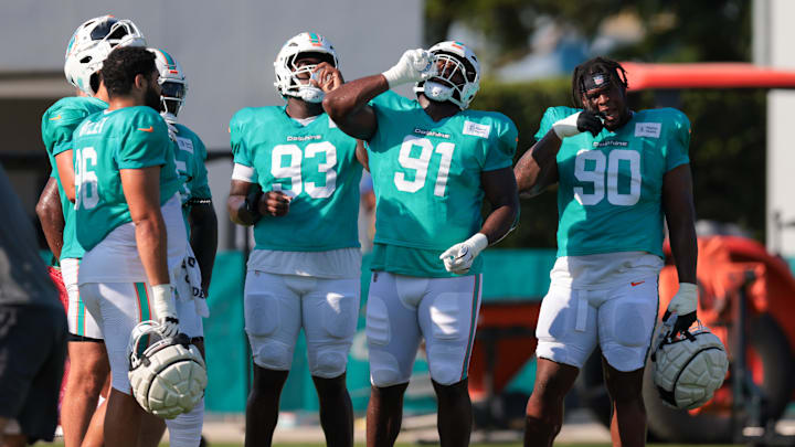 Miami Dolphins defensive tackle Zeek Biggers (93), defensive tackle Matthew Butler (91), and defensive tackle Kenneth Grant (90) hydrate during training camp at Baptist Health Training Complex. Miami Dolphins defensive tackle Zeek Biggers (93), defensive tackle Matthew Butler (91), and defensive tackle Kenneth Grant (90) hydrate during training camp at Baptist Health Training Complex.