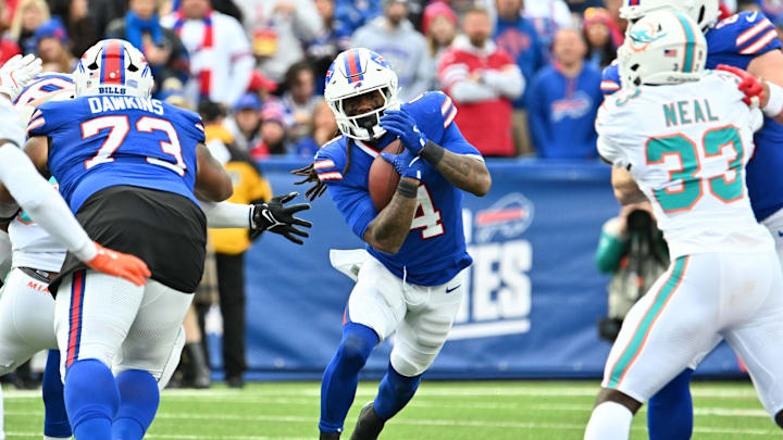 Nov 3, 2024; Orchard Park, New York, USA; Buffalo Bills running back James Cook (4) runs the ball against the Miami Dolphins in the third quarter at Highmark Stadium. Mandatory Credit: Mark Konezny-Imagn Images