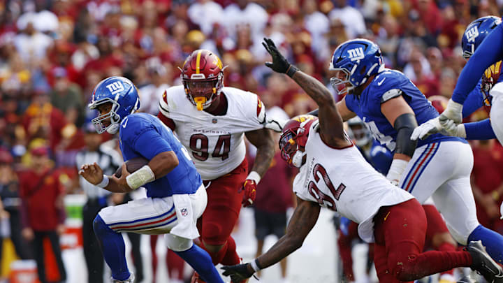 Sep 7, 2025; Landover, Maryland, USA; New York Giants quarterback Russell Wilson (3) runs away from Washington Commanders defensive end Dorance Armstrong (92) during the fourth quarter at Northwest Stadium. Sep 7, 2025; Landover, Maryland, USA; New York Giants quarterback Russell Wilson (3) runs away from Washington Commanders defensive end Dorance Armstrong (92) during the fourth quarter at Northwest Stadium.