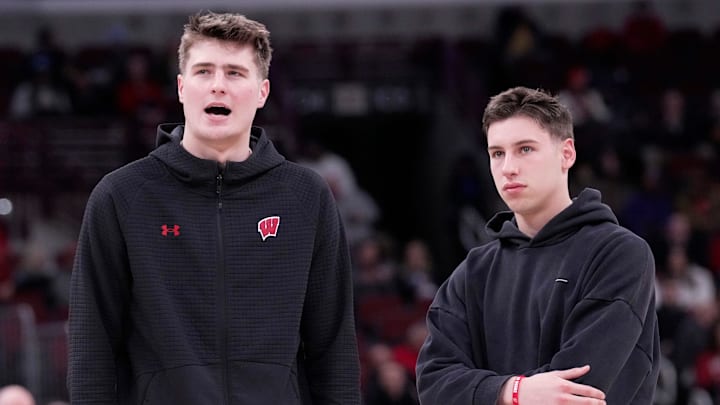 Injured Wisconsin forward Nolan Winter, left, talks with injured guard Jack Janicki before the second half of their third round game of the Big Ten tournament Thursday, March 12, 2026 at the United Center in Chicago, Illinois. Wisconsin beat Washington 85-82.