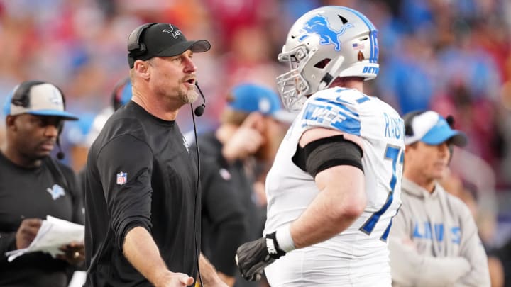 Detroit Lions head coach Dan Campbell high fives center Frank Ragnow (77) after a play against the San Francisco 49ers during the first half of the NFC Championship football game at Levi's Stadium. 