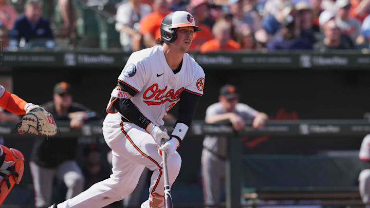 Sep 19, 2024; Baltimore, Maryland, USA; Baltimore Orioles catcher Adley Rutschman (35) drives in a run on his fourth inning double against the San Francisco Giants at Oriole Park at Camden Yards.