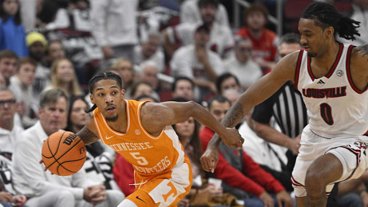 Nov 9, 2024; Louisville, Kentucky, USA; Tennessee Volunteers guard Zakai Zeigler (5) dribbles against Louisville Cardinals forward James Scott (0) during the first half at KFC Yum! Center. Mandatory Credit: Jamie Rhodes-Imagn Images Nov 9, 2024; Louisville, Kentucky, USA; Tennessee Volunteers guard Zakai Zeigler (5) dribbles against Louisville Cardinals forward James Scott (0) during the first half at KFC Yum! Center. Mandatory Credit: Jamie Rhodes-Imagn Images