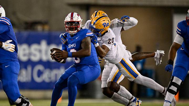 Nov 2, 2024; Dallas, Texas, USA; Southern Methodist Mustangs quarterback Keldric Luster (6) attempts to break the tackle of Pittsburgh Panthers linebacker Jordan Bass (20) during the second half at Gerald J. Ford Stadium. Mandatory Credit: Jerome Miron-Imagn Images Nov 2, 2024; Dallas, Texas, USA; Southern Methodist Mustangs quarterback Keldric Luster (6) attempts to break the tackle of Pittsburgh Panthers linebacker Jordan Bass (20) during the second half at Gerald J. Ford Stadium. Mandatory Credit: Jerome Miron-Imagn Images