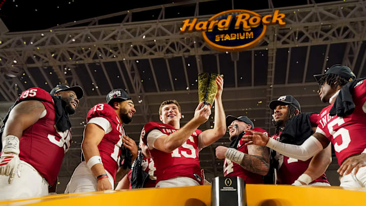 Indiana Hoosiers quarterback Fernando Mendoza (15) hoists the championship trophy Monday, Jan. 19, 2026, after defeating the Miami (FL) Hurricanes in the College Football Playoff National Championship college football game at Hard Rock Stadium in Miami Gardens.