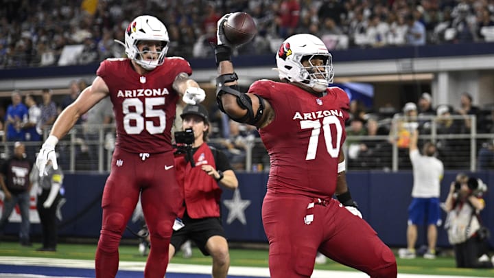 Nov 3, 2025; Arlington, Texas, USA; Arizona Cardinals offensive tackle Paris Johnson Jr. (70) spikes the ball after a touchdown by tight end Trey McBride (85) in the second half against the Dallas Cowboys at AT&T Stadium. Mandatory Credit: Jerome Miron-Imagn Images Nov 3, 2025; Arlington, Texas, USA; Arizona Cardinals offensive tackle Paris Johnson Jr. (70) spikes the ball after a touchdown by tight end Trey McBride (85) in the second half against the Dallas Cowboys at AT&T Stadium. Mandatory Credit: Jerome Miron-Imagn Images