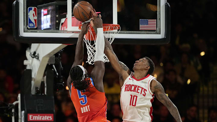 Dec 14, 2024; Las Vegas, Nevada, USA; Oklahoma City Thunder guard Luguentz Dort (5) shoots against Houston Rockets forward Jabari Smith Jr. (10) during the fourth quarter in a semifinal of the 2024 Emirates NBA Cup at T-Mobile Arena. Mandatory Credit: Kyle Terada-Imagn Images