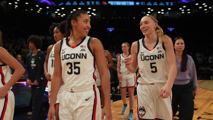 Dec 7, 2024; Brooklyn, New York, USA; Connecticut Huskies guard Azzi Fudd (35) and Connecticut Huskies guard Paige Bueckers (5) celebrate after the game against the Louisville Cardinals at Barclays Center. Mandatory Credit: Lucas Boland-Imagn Images Dec 7, 2024; Brooklyn, New York, USA; Connecticut Huskies guard Azzi Fudd (35) and Connecticut Huskies guard Paige Bueckers (5) celebrate after the game against the Louisville Cardinals at Barclays Center. Mandatory Credit: Lucas Boland-Imagn Images