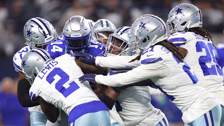 Nov 30, 2023; Arlington, Texas, USA; Seattle Seahawks wide receiver DK Metcalf (14) is tackled by Dallas Cowboys cornerback Jourdan Lewis (2) and cornerback Stephon Gilmore (21) during the first half at AT&T Stadium. Mandatory Credit: Tim Heitman-Imagn Images