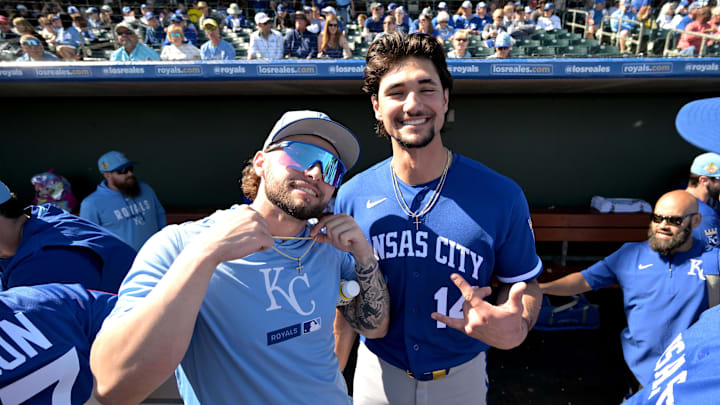 Feb 20, 2026; Surprise, Arizona, USA;  Kansas City Royals catcher Carter Jensen (22) and right fielder Jac Caglianone (14) in the dugout prior to the game against the Texas Rangers at Surprise Stadium. Mandatory Credit: Jayne Kamin-Oncea-Imagn Images