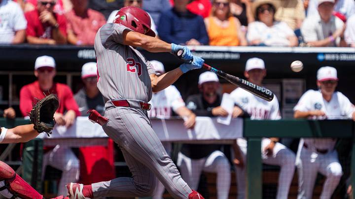 Jun 13, 2026; Omaha, NE, USA; Oklahoma Sooners designated hitter Trey Gambill (20) hits a two RBI double against the Alabama Crimson Tide during the first inning at Charles Schwab Field. Mandatory Credit: Dylan Widger-Imagn Images