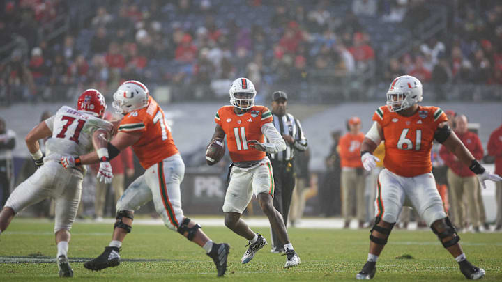 Dec 28, 2023; Bronx, NY, USA; Miami Hurricanes quarterback Jacurri Brown (11) drops back to pass