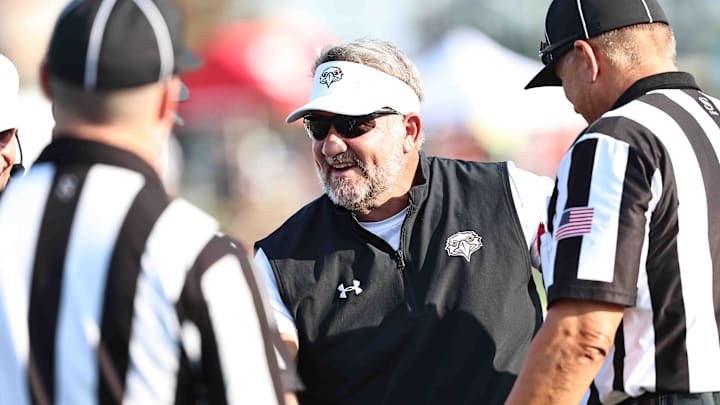 Lakota West head coach Tom Bolden talks with the referees before their game against St. Xavier Friday, Aug. 23, 2024.