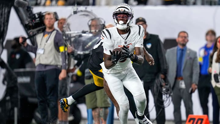 Cincinnati Bengals wide receiver Tee Higgins (5) catches a pass to being the Bengals within field goal range late in the fourth quarter of the NFL Week 7 game between the Cincinnati Bengals and the Pittsburgh Steelers at Paycor Stadium in downtown Cincinnati on Thursday, Oct. 16, 2025. The Bengals won, 33-31.