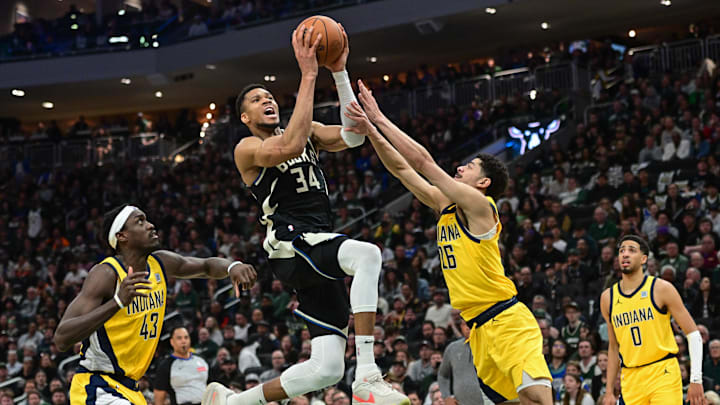 Apr 27, 2025; Milwaukee, Wisconsin, USA; Milwaukee Bucks forward Giannis Antetokounmpo (34) takes a shot between Indiana Pacers forward Pascal Siakam (43) and  guard Ben Sheppard (26) in the third quarter during game four of first round for the 2024 NBA Playoffs at Fiserv Forum. Mandatory Credit: Benny Sieu-Imagn Images