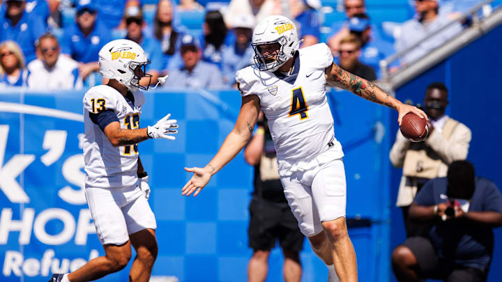 Aug 30, 2025; Lexington, Kentucky, USA; Toledo Rockets quarterback Tucker Gleason (4) celebrates with wide receiver Cooper Rusk (13) after scoring a touchdown during the fourth quarter against the Kentucky Wildcats at Kroger Field. Mandatory Credit: Jordan Prather-Imagn Images