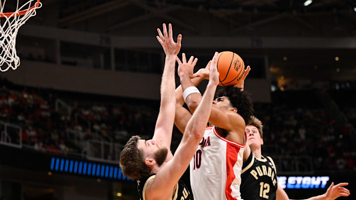 Mar 28, 2026; San Jose, CA, USA; Arizona Wildcats forward Koa Peat (10) shoots the ball against Purdue Boilermakers center Oscar Cluff (45) and Purdue Boilermakers center Daniel Jacobsen (12) in the first half during an Elite Eight game of the West Regional of the men's 2026 NCAA Tournament at SAP Center. Mandatory Credit: Eakin Howard-Imagn Images