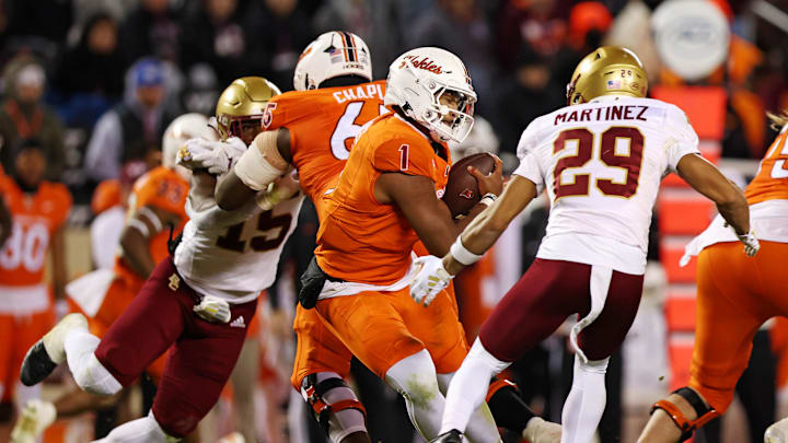 Oct 17, 2024; Blacksburg, Virginia, USA; Virginia Tech Hokies quarterback Kyron Drones (1) is sacked by Boston College Eagles defensive back Cameron Martinez (29) during the third quarter at Lane Stadium. Mandatory Credit: Peter Casey-Imagn Images