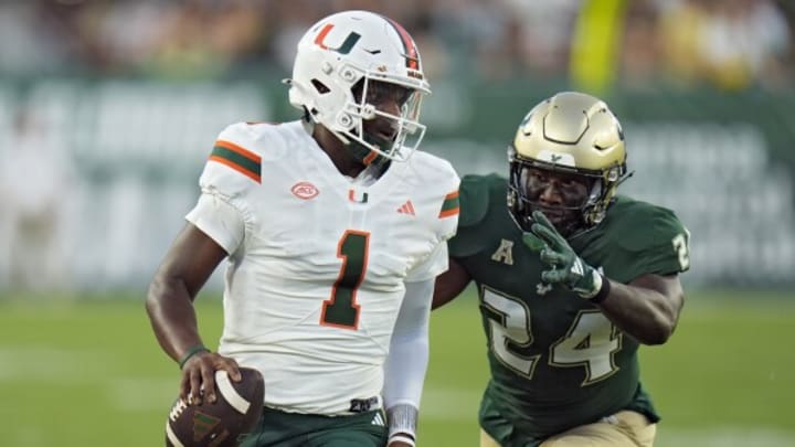 Miami quarterback Cam Ward (1) trots out of bounds during the first half of the Canes' game versus the University of South Florida Bulls on September 21st, 2024 in Tampa, Florida. Mandatory Credit: AP Photo/Chris O'Meara