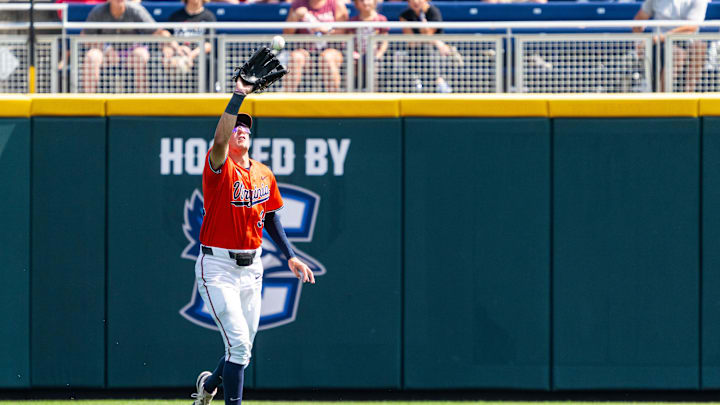 Jun 16, 2024; Omaha, NE, USA; Virginia Cavaliers center fielder Harrison Didawick (34) gets an out against the Florida State Seminoles during the eighth inning at Charles Schwab Field Omaha. Mandatory Credit: Dylan Widger-Imagn Images