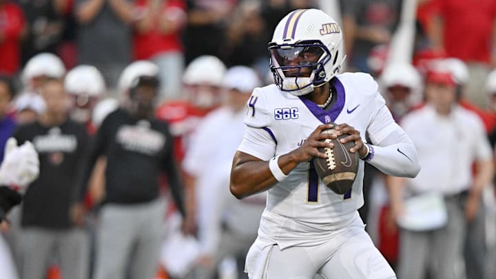 Sep 5, 2025; Louisville, Kentucky, USA;  James Madison Dukes quarterback Alonza Barnett III (14) looks to pass against the Louisville Cardinals during the first half at L&N Federal Credit Union Stadium. Louisville defeated James Madison 28-14. Mandatory Credit: Jamie Rhodes-Imagn Images