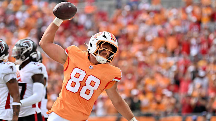Tampa Bay Buccaneers tight end Cade Otton (88) spikes the ball after scoring a touchdown in the first half  against the Atlanta Falcons at Raymond James Stadium. 