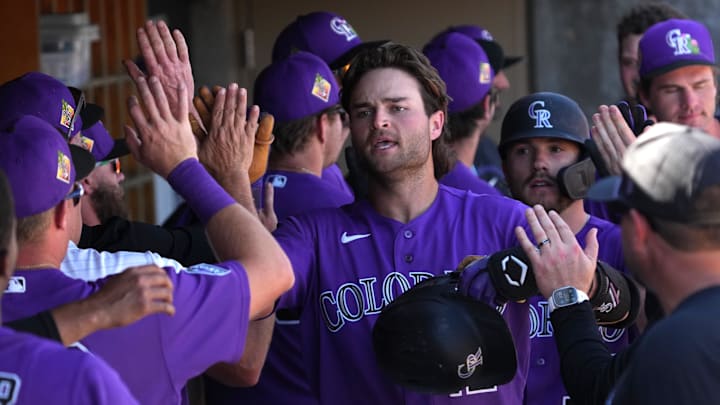 Mar 4, 2026; Scottsdale, AZ, USA; Colorado Rockies third baseman Kyle Karros (12) celebrates with teammates after hitting a a two run home run against the United States in the fourth inning at Salt River Fields. Mandatory Credit: Rick Scuteri-Imagn Images