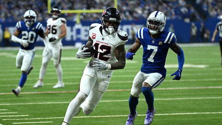 Nov 30, 2025; Indianapolis, Indiana, USA; Houston Texans wide receiver Nico Collins (12) runs after a catch against Indianapolis Colts cornerback Charvarius Ward (7) during the first half at Lucas Oil Stadium. Mandatory Credit: Robert Goddin-Imagn Images