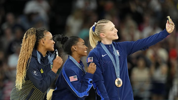 Aug 3, 2024; Paris, France; Rebeca Andrade of Brazil, Simone Biles and Jade Carey of the United States pose for a photo during the medal ceremony for the vault on the first day of gymnastics event finals during the Paris 2024 Olympic Summer Games at Bercy Arena. Aug 3, 2024; Paris, France; Rebeca Andrade of Brazil, Simone Biles and Jade Carey of the United States pose for a photo during the medal ceremony for the vault on the first day of gymnastics event finals during the Paris 2024 Olympic Summer Games at Bercy Arena.