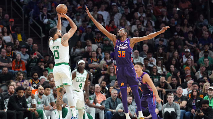 Mar 9, 2024; Phoenix, Arizona, USA; Boston Celtics forward Jayson Tatum (0) shoots over Phoenix Suns forward Kevin Durant (35) during the first half at Footprint Center. Mandatory Credit: Joe Camporeale-Imagn Images