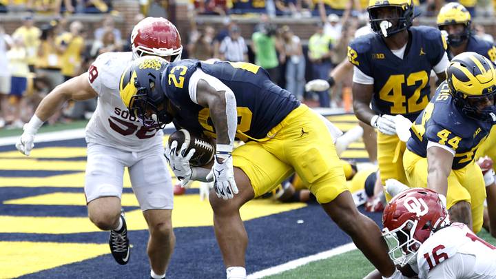 Sep 12, 2026; Ann Arbor, Michigan, USA; Michigan Wolverines running back Jordan Marshall (23) carries the ball for a touchdown defended by Oklahoma Sooners defensive line Danny Okoye (16) during the fourth quarter at Michigan Stadium. Mandatory Credit: Rick Osentoski-Imagn Images Sep 12, 2026; Ann Arbor, Michigan, USA; Michigan Wolverines running back Jordan Marshall (23) carries the ball for a touchdown defended by Oklahoma Sooners defensive line Danny Okoye (16) during the fourth quarter at Michigan Stadium. Mandatory Credit: Rick Osentoski-Imagn Images
