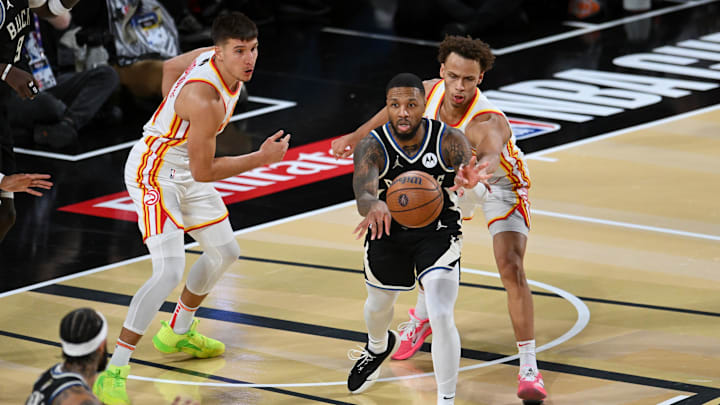 Dec 14, 2024; Las Vegas, Nevada, USA; Milwaukee Bucks guard Damian Lillard (0) passes against the Atlanta Hawks during the fourth quarter in a semifinal of the 2024 Emirates NBA Cup at T-Mobile Arena. Mandatory Credit: Candice Ward-Imagn Images Dec 14, 2024; Las Vegas, Nevada, USA; Milwaukee Bucks guard Damian Lillard (0) passes against the Atlanta Hawks during the fourth quarter in a semifinal of the 2024 Emirates NBA Cup at T-Mobile Arena. Mandatory Credit: Candice Ward-Imagn Images