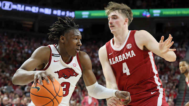 Arkansas Razorbacks forward Adou Thiero, left, who graduated from Quaker Valley High School outside of Pittsburgh, drives against Alabama Crimson Tide forward Grant Nelson during the first half at Bud Walton Arena in Fayetteville, Ark., earlier this season. Mandatory Credit: Nelson Chenault-Imagn Images