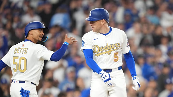 Mar 28, 2025; Los Angeles, California, USA;  Los Angeles Dodgers first baseman Freddie Freeman (5) celebrates a homerun with shortstop Mookie Betts (50) who also scored against the Detroit Tigers during the sixth inning at Dodger Stadium. Mandatory Credit: Kirby Lee-Imagn Images