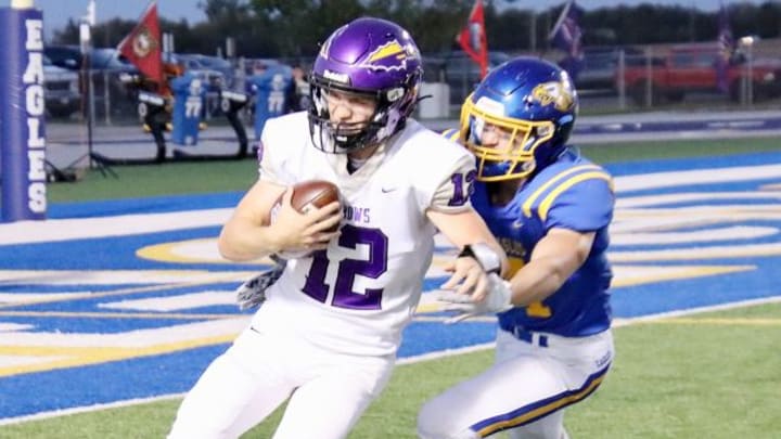 Watertown quarterback attempts to elude an Aberdeen Central defender