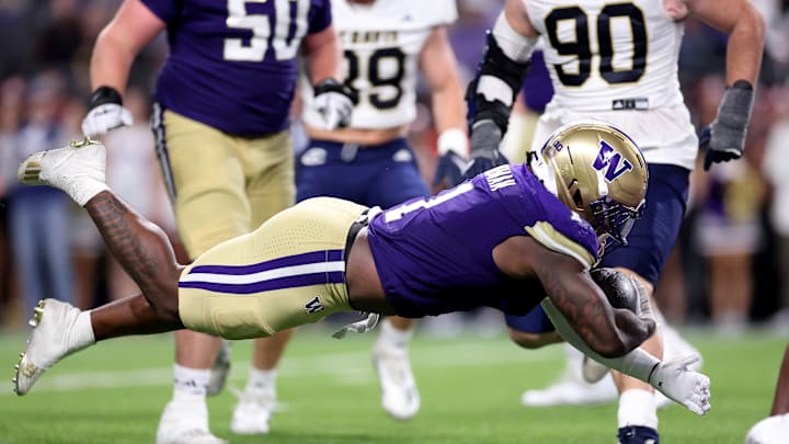 Washington Huskies running back Jonah Coleman dives into the endzone during the team's 70-10 victory over the UC Davis Aggies. Coleman finished the game with a program record-equaling five rushing touchdowns.