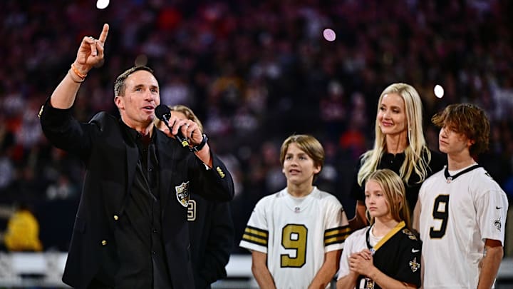 Former QB Drew Brees speaks to fans at Superdome during ceremony for his entry into Saints' Hall of Fame as his family looks on Thursday night at halftime with Saints down 16-3. They lost 33-10 to Denver and coach Sean Payton, formerly Brees' Saints coach.