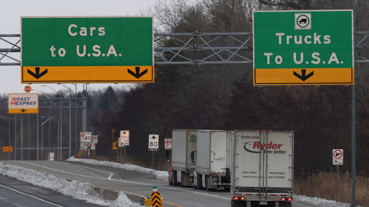 Trucks cross the border into the United States.