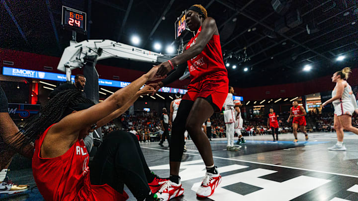Atlanta Dream All-Star Rhyne Howard helps up teammate Allisha Gray