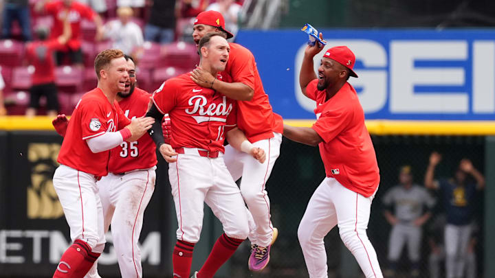 The Cincinnati Reds celebrate Austin Hays' walk-off hit against the Milwaukee Brewers.