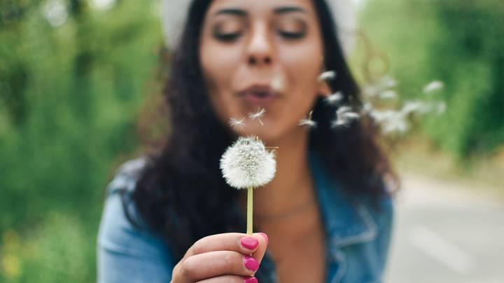 Woman blowing dandelion Woman blowing dandelion