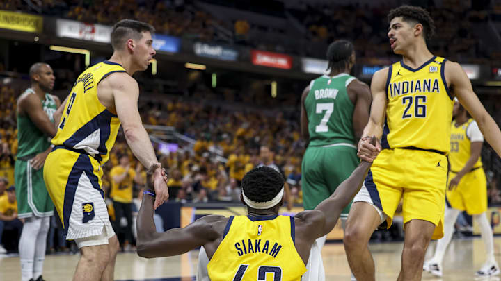 May 27, 2024; Indianapolis, Indiana, USA; Indiana Pacers guard Ben Sheppard (26) and Indiana Pacers guard T.J. McConnell (9) help Indiana Pacers forward Pascal Siakam (43) stand up during the second quarter during game four of the eastern conference finals for the 2024 NBA playoffs at Gainbridge Fieldhouse. Mandatory Credit: Trevor Ruszkowski-USA TODAY Sports
