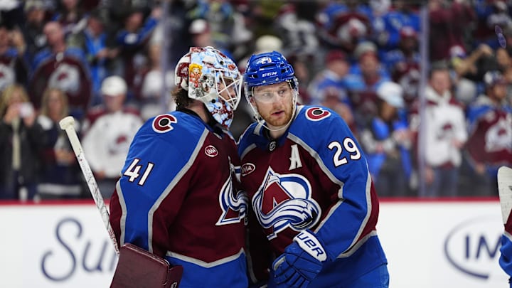 May 3, 2026; Denver, Colorado, USA; Colorado Avalanche goaltender Scott Wedgewood (41) and center Nathan MacKinnon (29) celebrate defeating the Minnesota Wild in game one of the second round of the 2026 Stanley Cup Playoffs at Ball Arena. Mandatory Credit: Ron Chenoy-Imagn Images