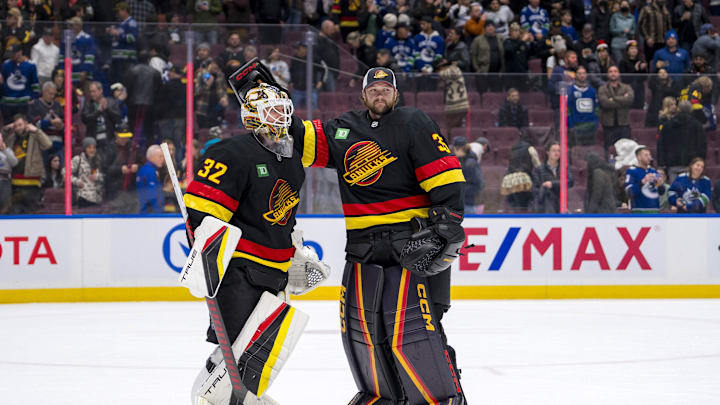 Dec 6, 2024; Vancouver, British Columbia, CAN; Vancouver Canucks goalie Kevin Lankinen (32) and goalie Thatcher Demko (35) celebrate the victory against the Columbus Blue Jackets at Rogers Arena. Mandatory Credit: Bob Frid-Imagn Images