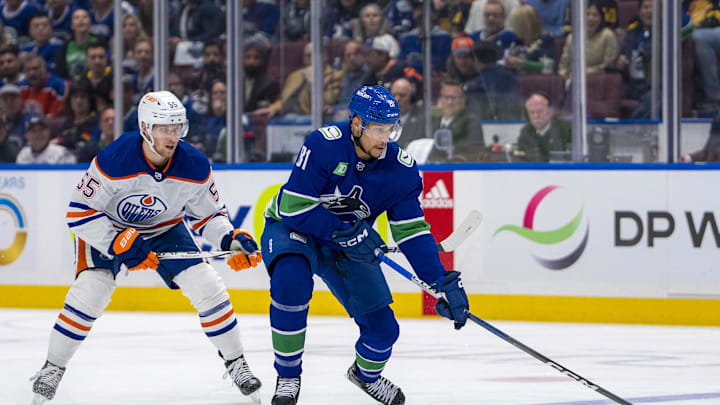May 20, 2024; Vancouver, British Columbia, CAN; Edmonton Oilers forward Dylan Holloway (55) watches Vancouver Canucks forward Dakota Joshua (81) hanlde the puck during the first period in game seven of the second round of the 2024 Stanley Cup Playoffs at Rogers Arena. Mandatory Credit: Bob Frid-USA TODAY Sports
