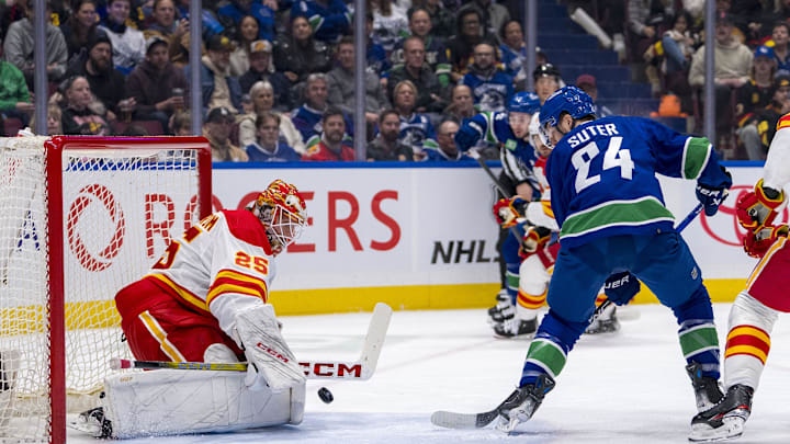 Apr 16, 2024; Vancouver, British Columbia, CAN; Calgary Flames goalie Jacob Markstrom (25) makes a save on Vancouver Canucks forward Pius Suter (24) in the first period at Rogers Arena. Mandatory Credit: Bob Frid-USA TODAY Sports